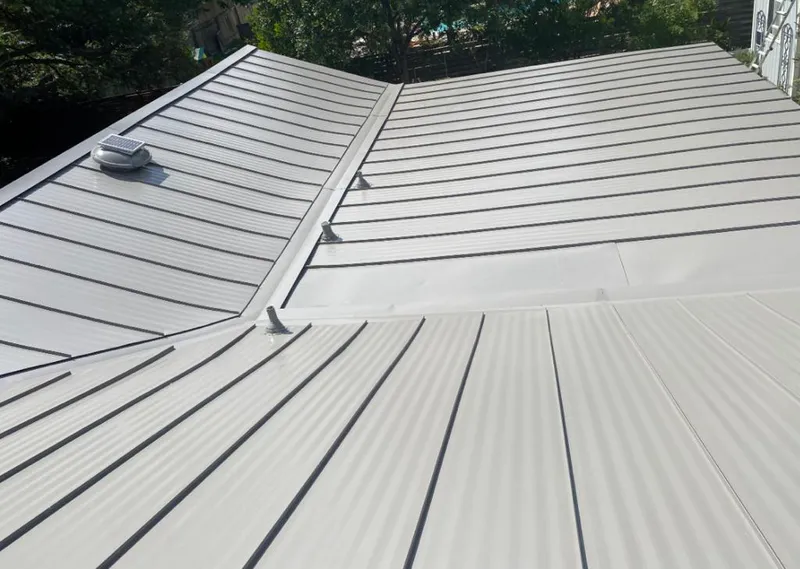 Solar attic fan installed on a metal roof for Roof Ventilation in Mascotte